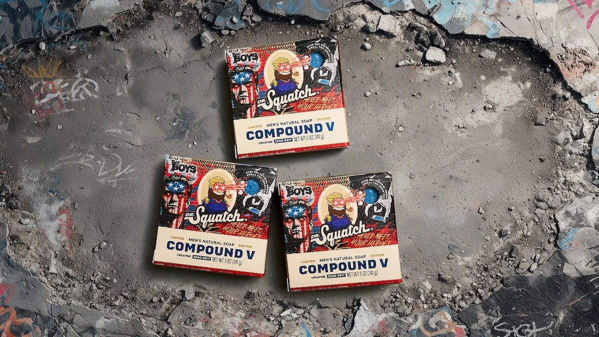Three bars of Dr. Squatch's Compound V soap with art of Homelander and other show decor