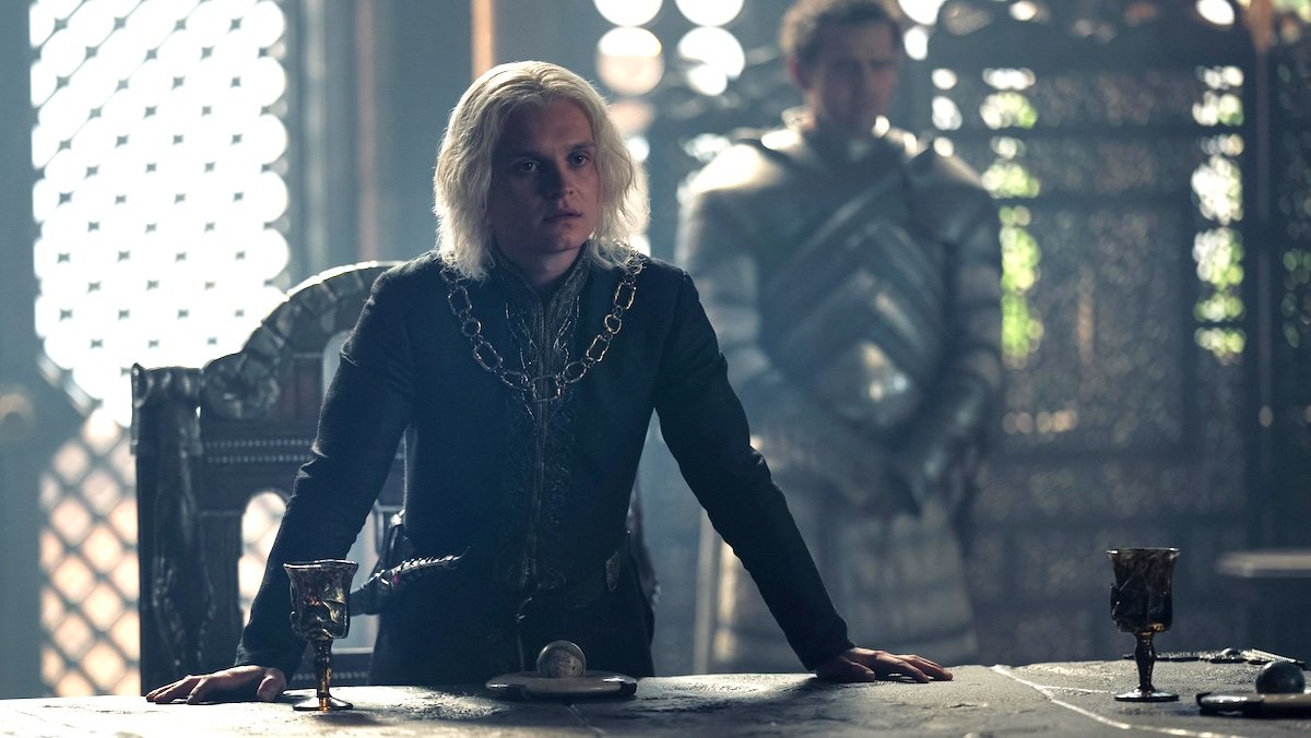 King Aegon stands at his table with a Kingsguard knight behind him on House of the Dragon
