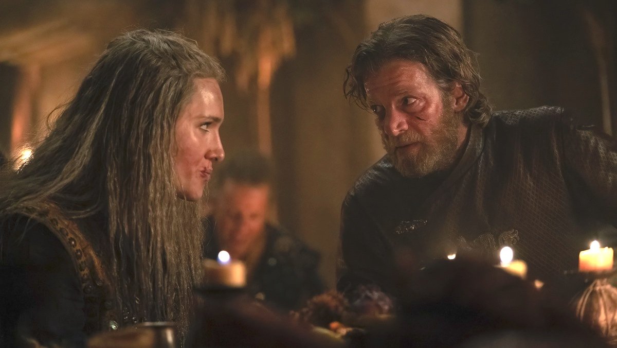 Lohar speaks to Tyland during a feast while both are seated on House of the Dragon