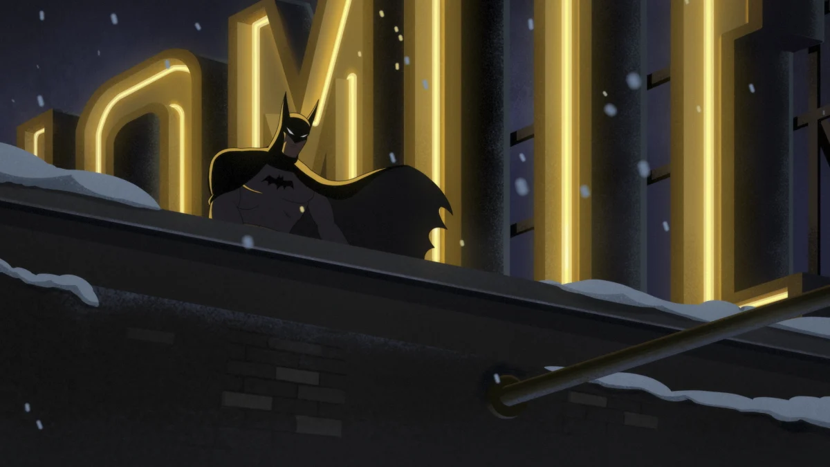 Batman overlooks Gotham in the snow.